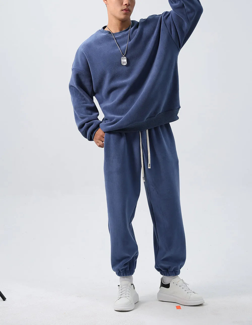 Man wearing a loose black polar fleece winter sports suit with crew neck coat and trousers