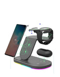 Black three-in-one wireless charging station with phone, watch and accessory on charging surfaces