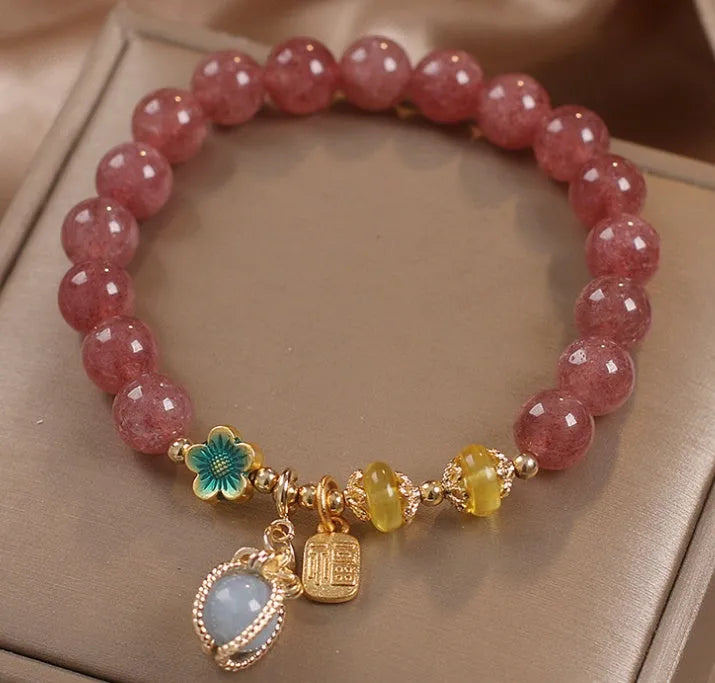 Red adjustable bracelet with strawberry quartz beads, alloy charm and rhinestone detailing