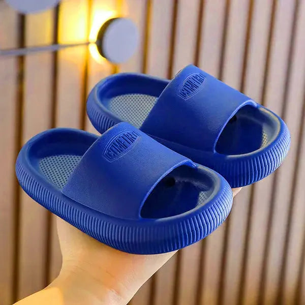 Colourful children's EVA slippers with textured sole, shown in blue, green, orange, pink, and yellow.