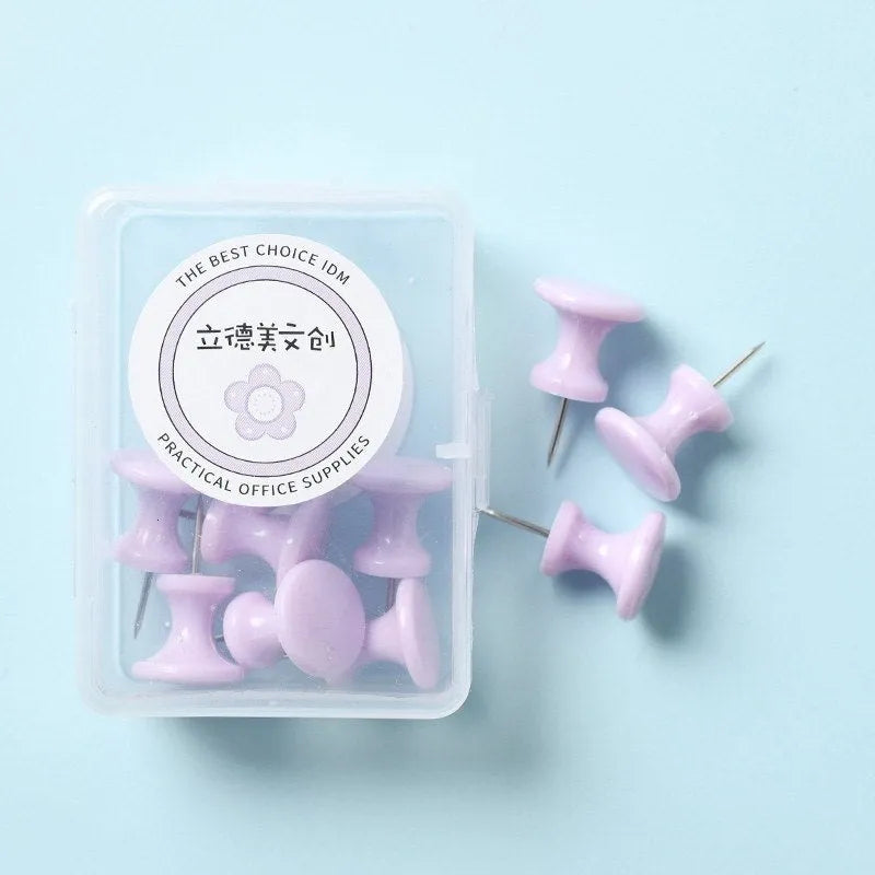 Plastic push pins in cherry blossom pink, mint green, and lavender colours, showing both large and small sizes on a white surface