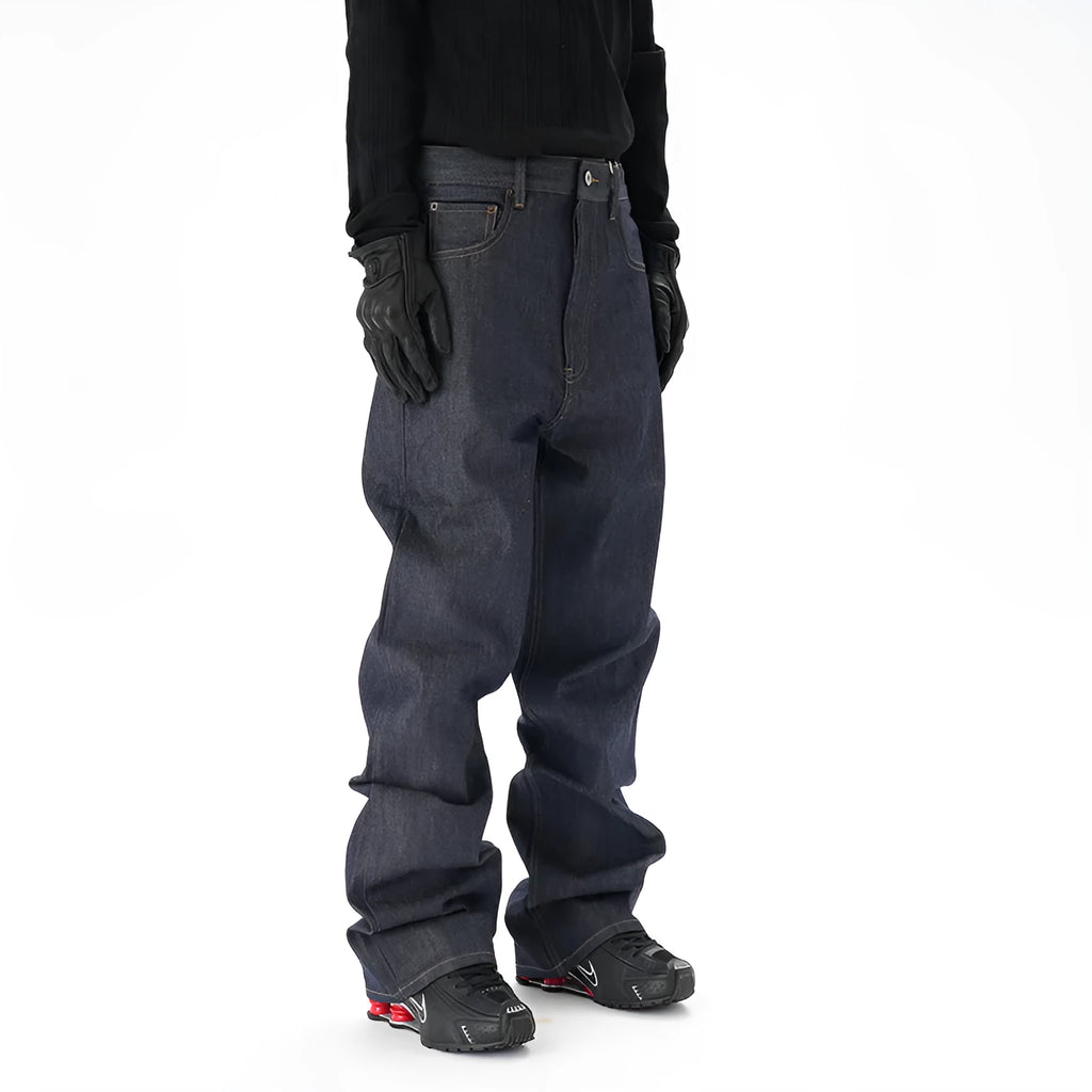 Man wearing dark blue loose fit straight leg denim jeans.