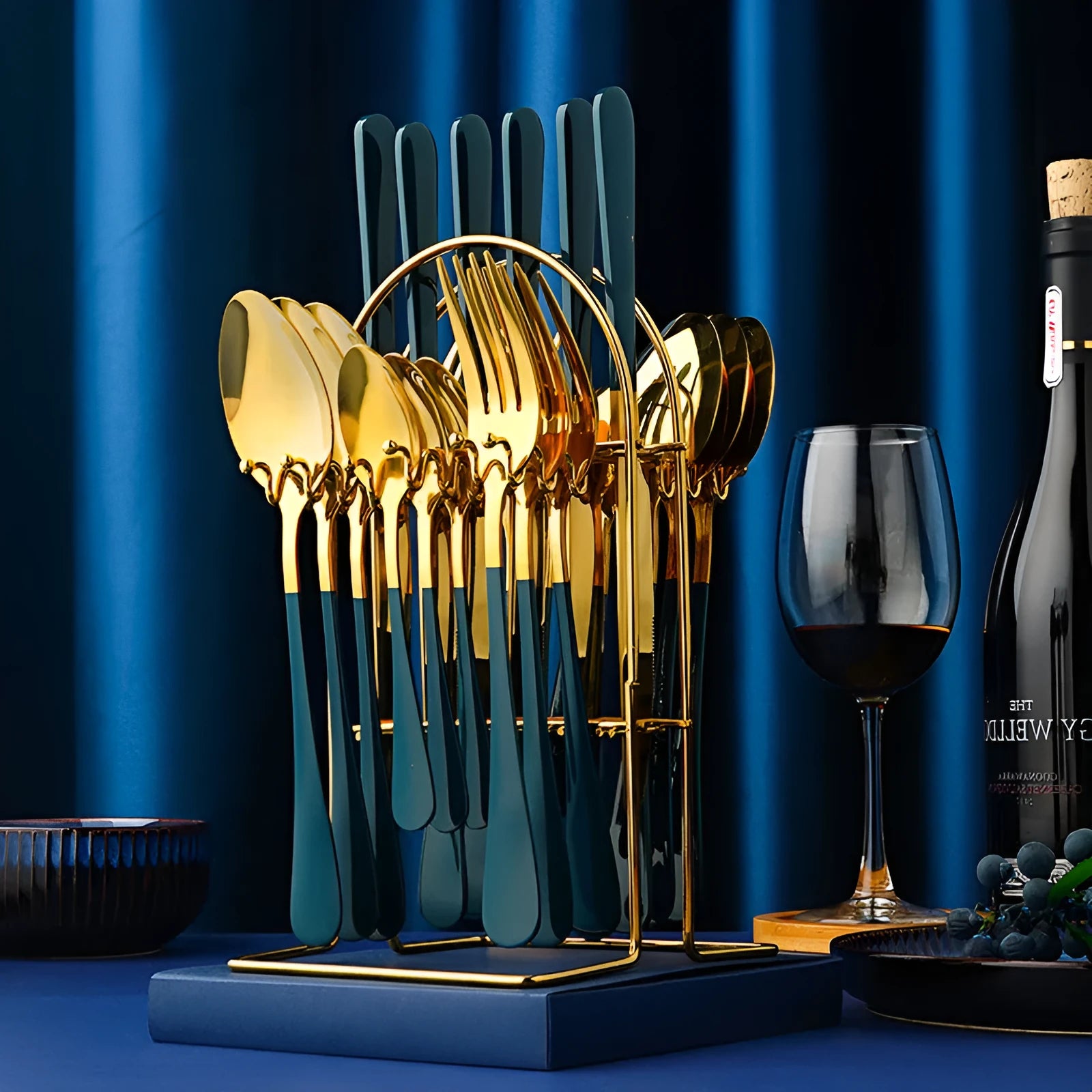 24-piece stainless steel cutlery set with knives, forks, spoons and teaspoons on a storage rack.
