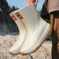 Men's mid-height PVC rain boot in beige colour with a round toe and plastic sole.