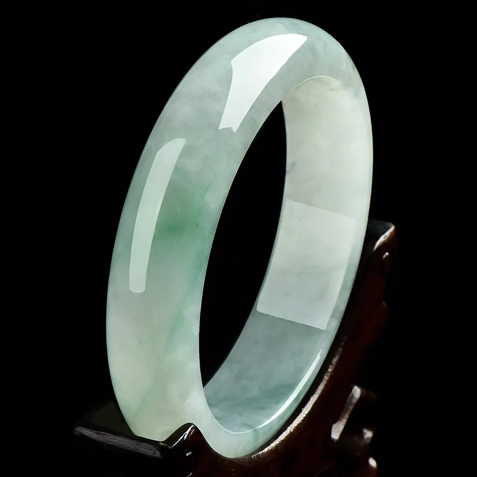 Light green jade bracelet on wrist showing natural stone texture and colour