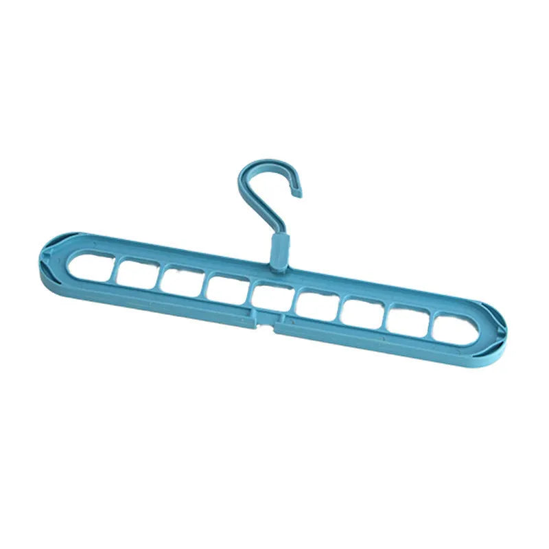 Green nine-hole plastic folding hanger for trousers and skirts showing multiple garment hanging points