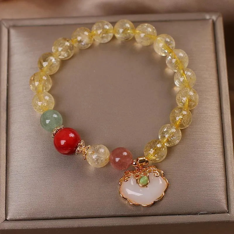 Women's adjustable alloy bracelet with a detailed natural citrine jade ruyi pendant in yellow tones.