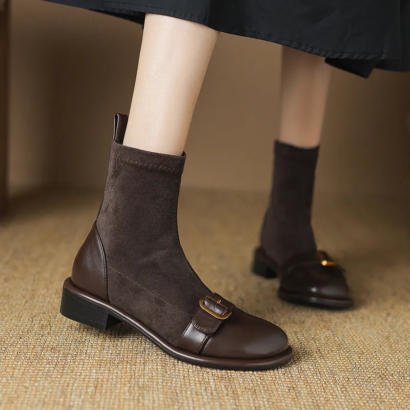 Black women's ankle boots with lace-up front and belt buckle stitching detail.
