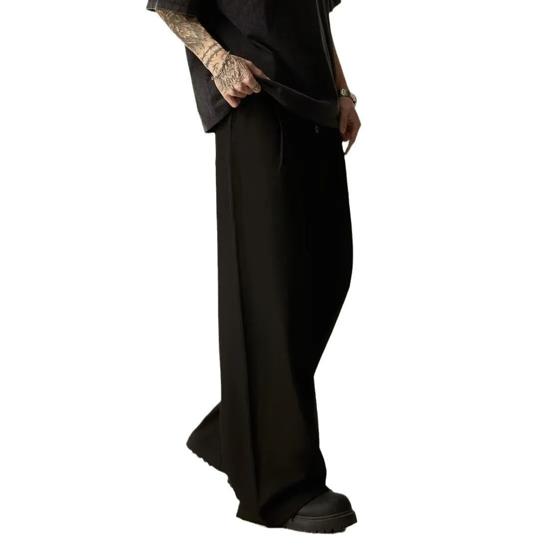 Men's solid black wide-leg casual trousers with a vertical tube cut and button fly.