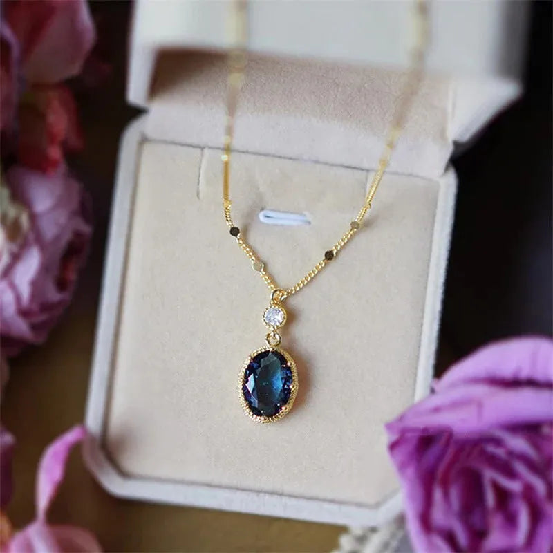 Gold geometric pendant necklace with French retro style on a model.