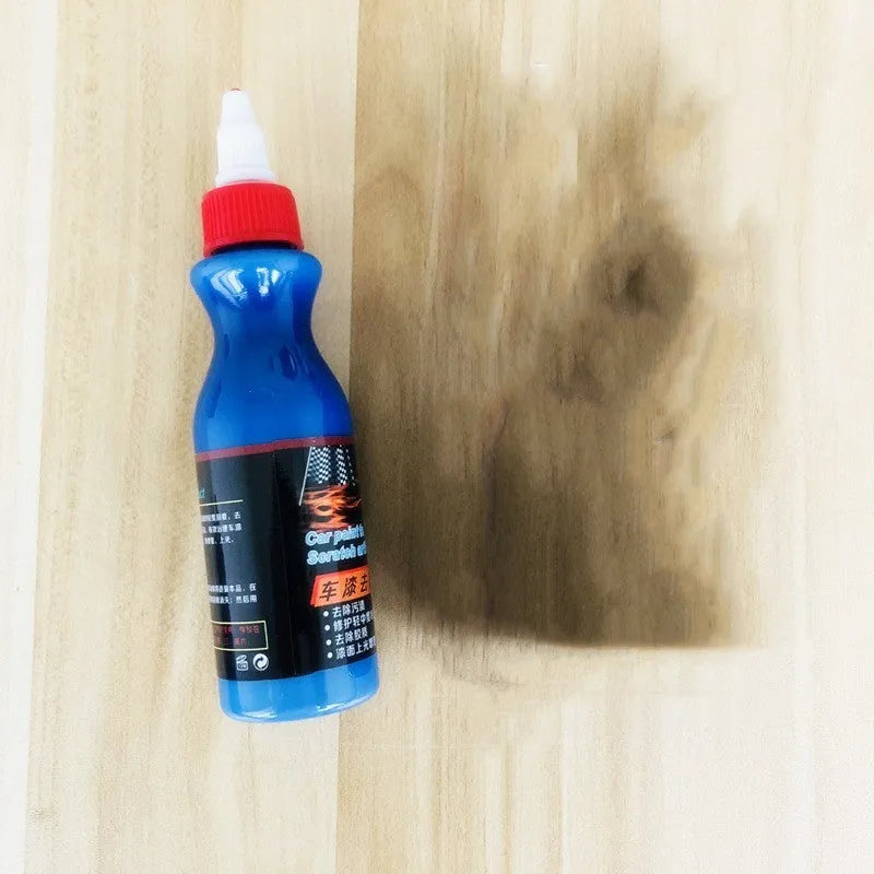 Small blue bottle of car scratch repair agent for wipe-on application to vehicle paint surfaces