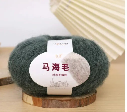 Ball of mohair yarn for DIY scarf knitting in one of 34 colours, including white, pink, blue, and green.