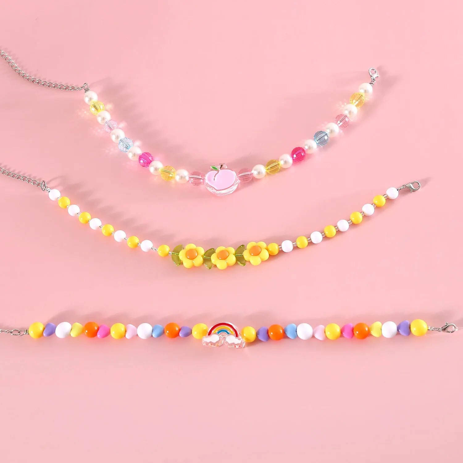 Colourful plastic bead pet necklace in small flower, rainbow, or peach design on an adjustable collar