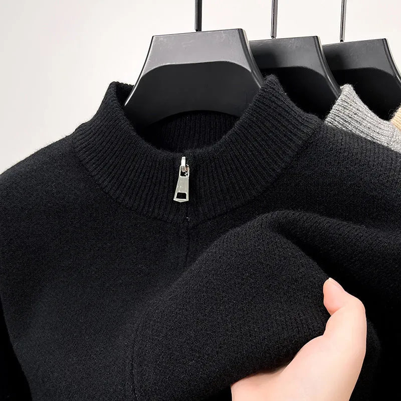 Man wearing a thick grey stand collar knitted cardigan with a zipper front.