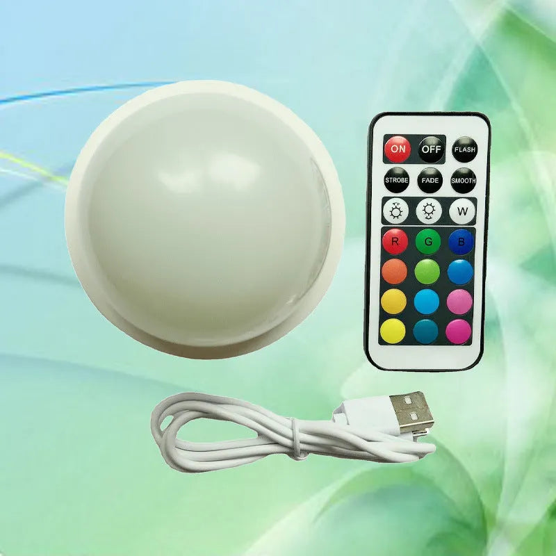 3D shooting night light with colourful gradient illumination and remote control on wooden surface
