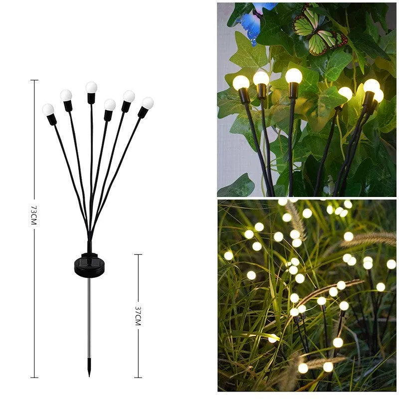 Solar-powered LED firefly garden spike light with multiple heads and a press-in ground plug on grass.