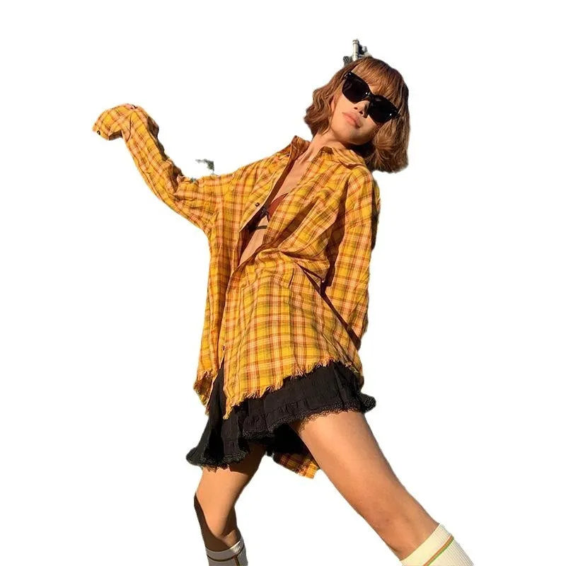 Dopamine yellow and black plaid shirt with a loose cardigan style fit on a hanger.