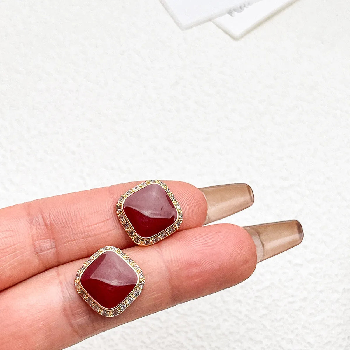 Red geometric square alloy earrings with clip-on fastening and embedded square design elements
