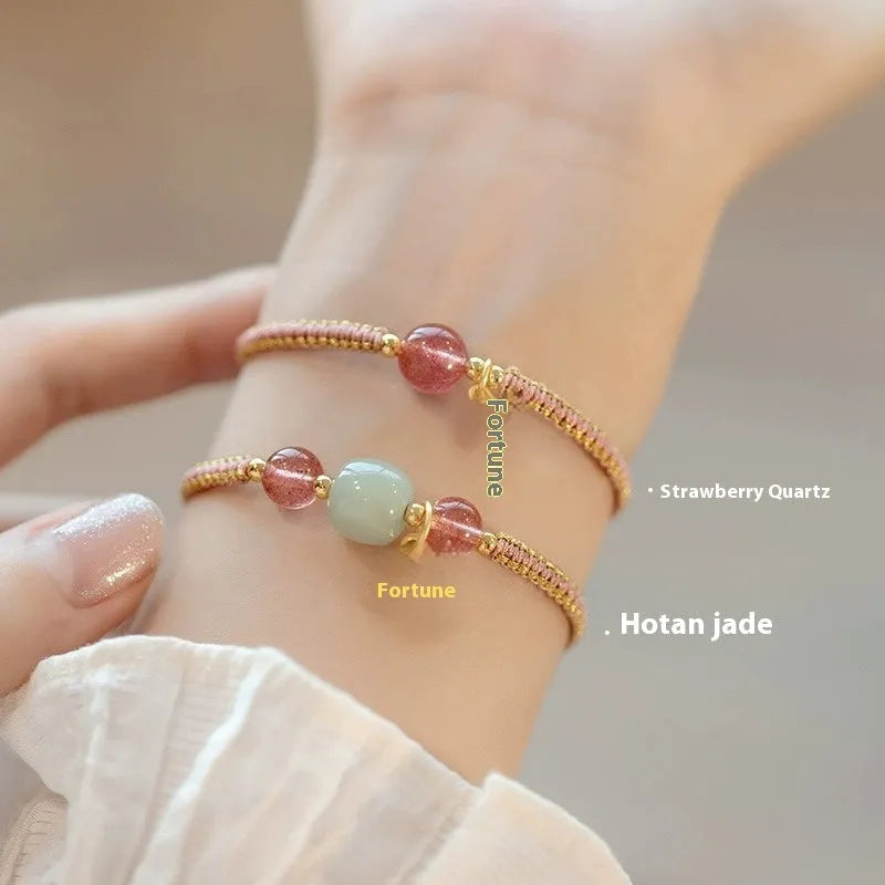 Adjustable red rope bracelet with a choice of Strawberry Quartz or Hetian Jade bead, showing the national style design.