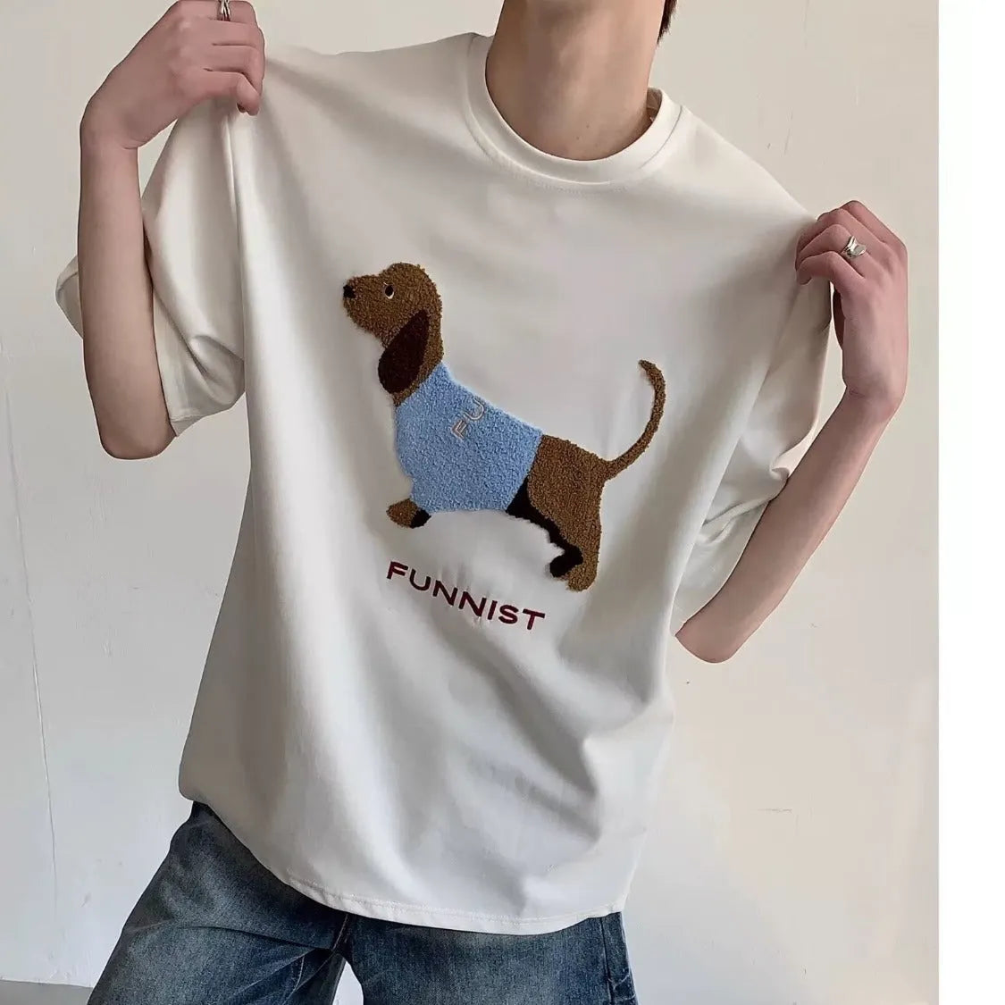 Men's gray cotton t-shirt with an embroidered cartoon sausage dog holding a blue towel.