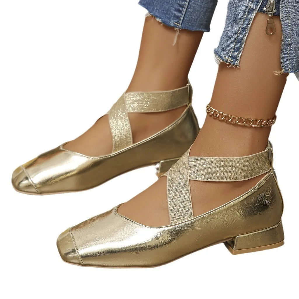 Gold women's slip-on evening pumps with skirt detail, square toe, and low rubber heel