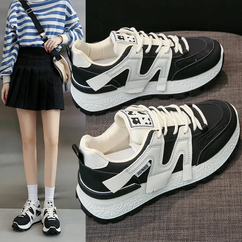 Women's low-top sneaker in black with artificial PU upper, rubber sole, and front lace-up closure.