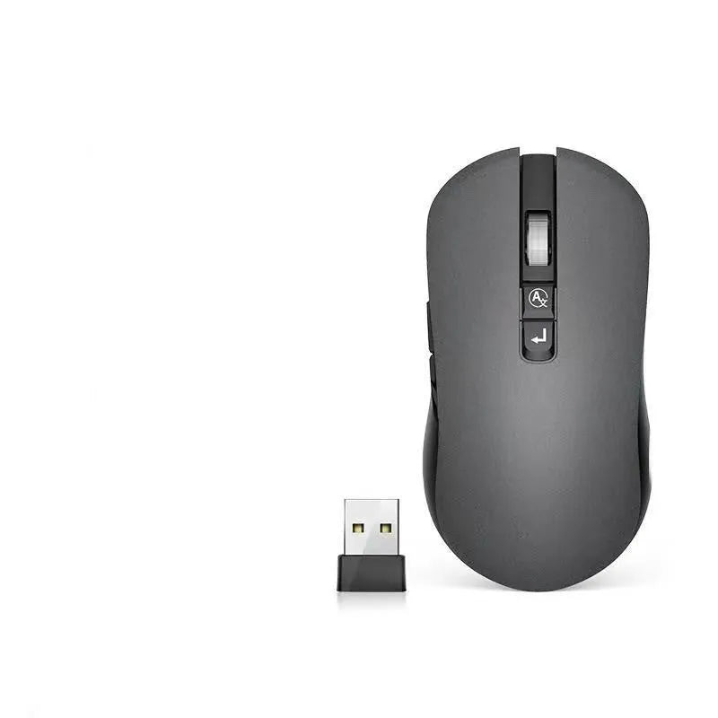 White wireless computer mouse with seven buttons on a desk, showing the USB receiver and voice transcription icon on screen.