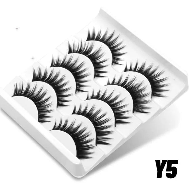 Box of natural false eyelashes with thick artificial fibre lashes and included glue tube