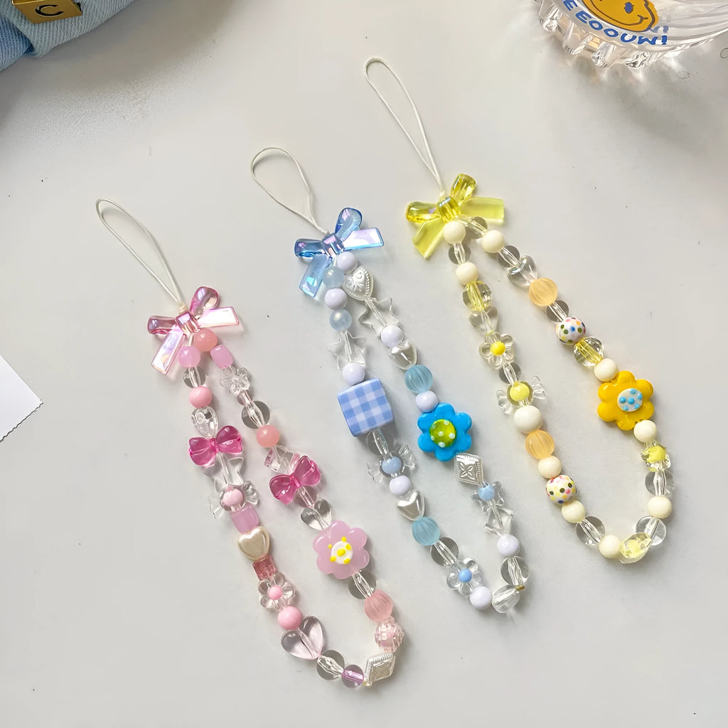 Blue, pink, and yellow floral beaded phone lanyard with plastic resin charms.