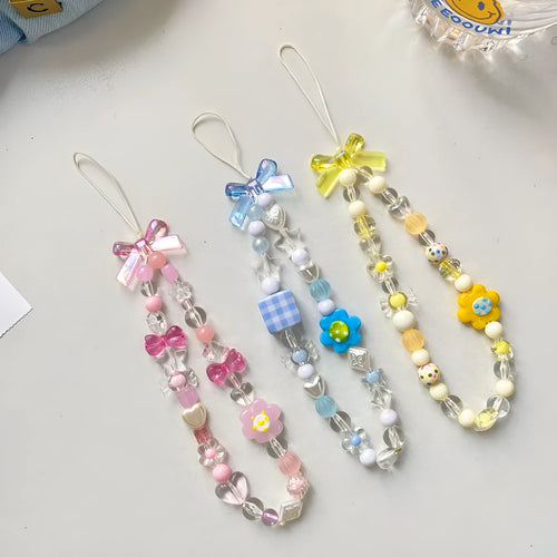 Blue, pink, and yellow floral beaded phone lanyard with plastic resin charms.
