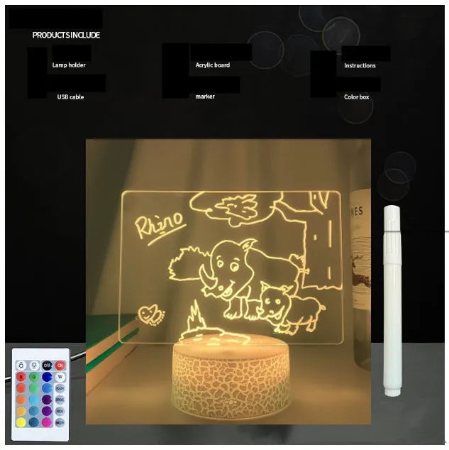 Black 3D acrylic message board night light with remote control and stylus on desk.