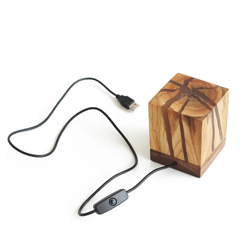 Creative crack night lamp in wood and PMMA with USB cable on bedside table