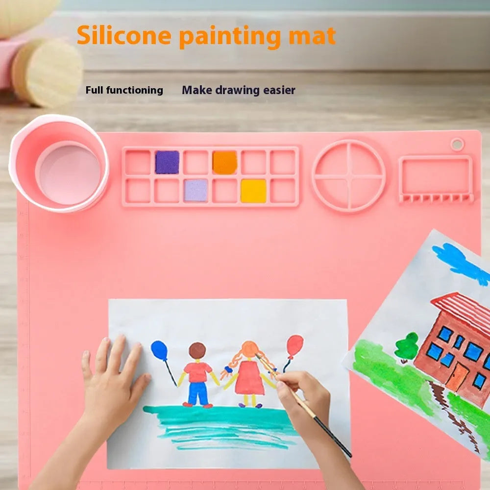 Green silicone painting mat measuring 50 by 40 cm, shown with two integrated bowls for paint or water.