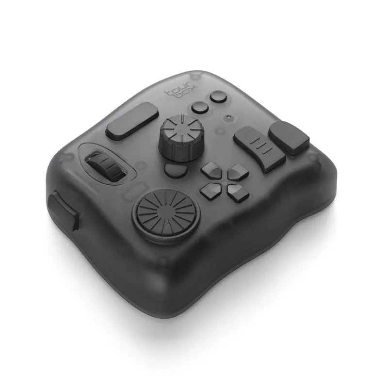 TourBox NEO black video editing controller with dials and buttons on a desk.