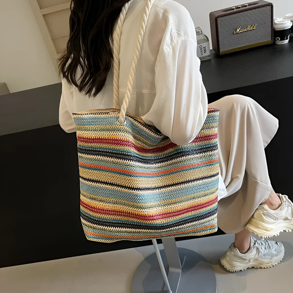 Blue woven nylon shoulder bag with straw-weave pattern and adjustable strap