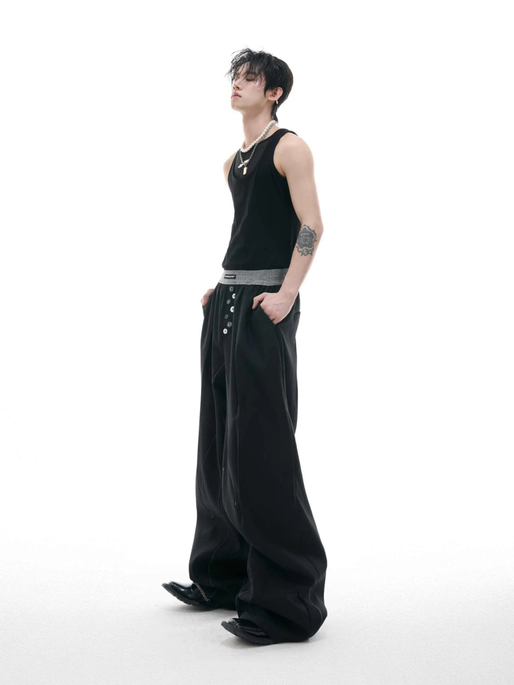Straight-leg high-waisted casual trousers with a button-open front seam detail in black.