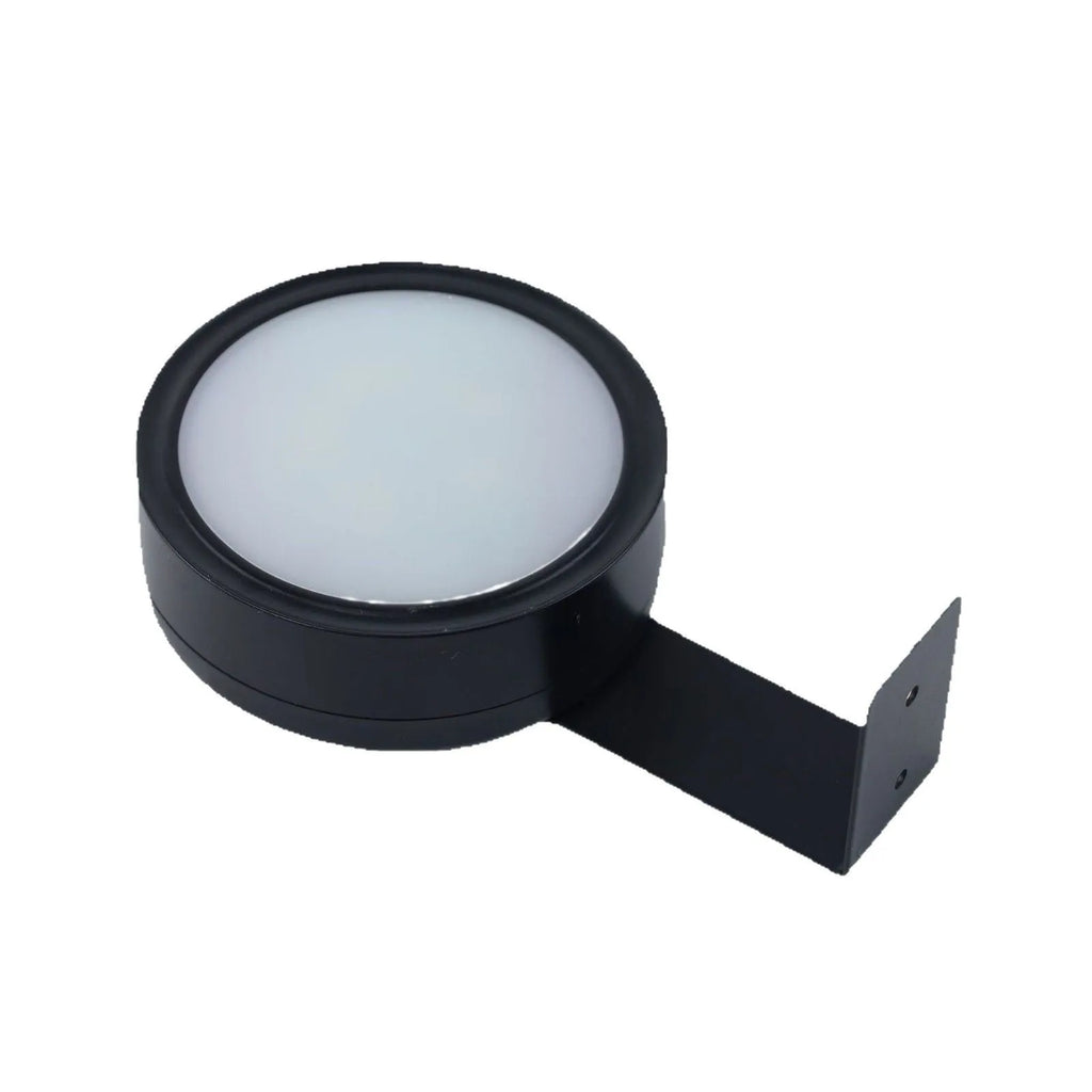 Black magnetic wireless LED lamp with remote control mounted next to a painting on a wall.