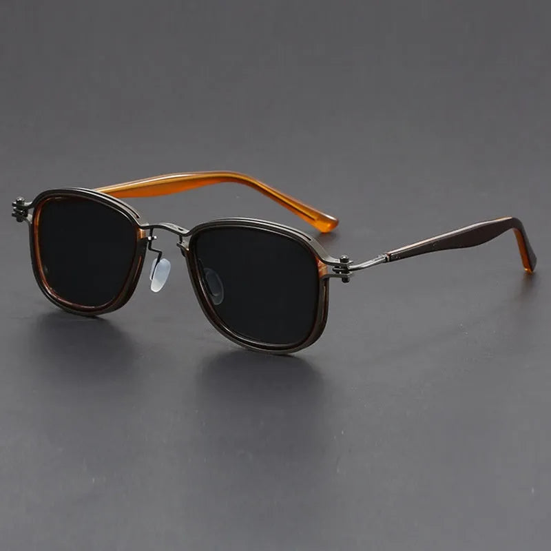 Retro square sunglasses with graphic lightning bolt design on black and gold frames.