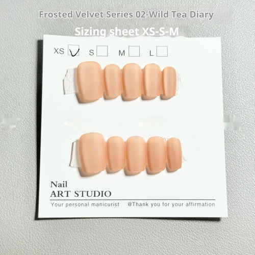 Frosted velvet Cat's Eye Aurora artificial nail art set in short ladder sizes on a display hand.