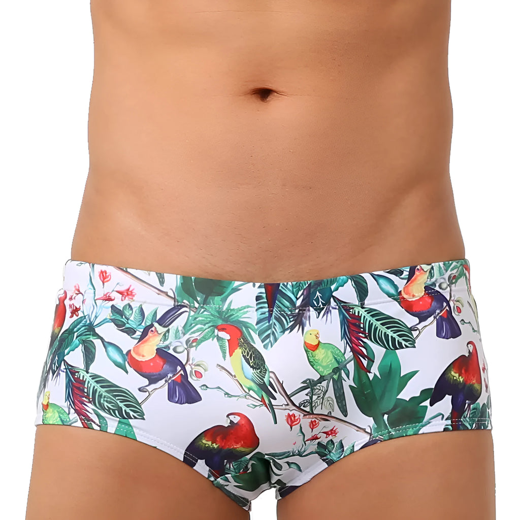 Men's blue swimming trunks with a detailed floral and bird print pattern, small boxer style