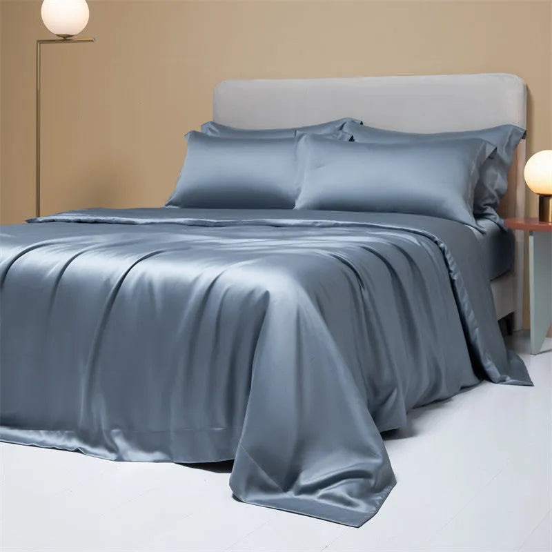 Luxury Lenzing Tencel bedding set in Aurora Blue on a bed, showing quilt cover, sheet, and two pillowcases.