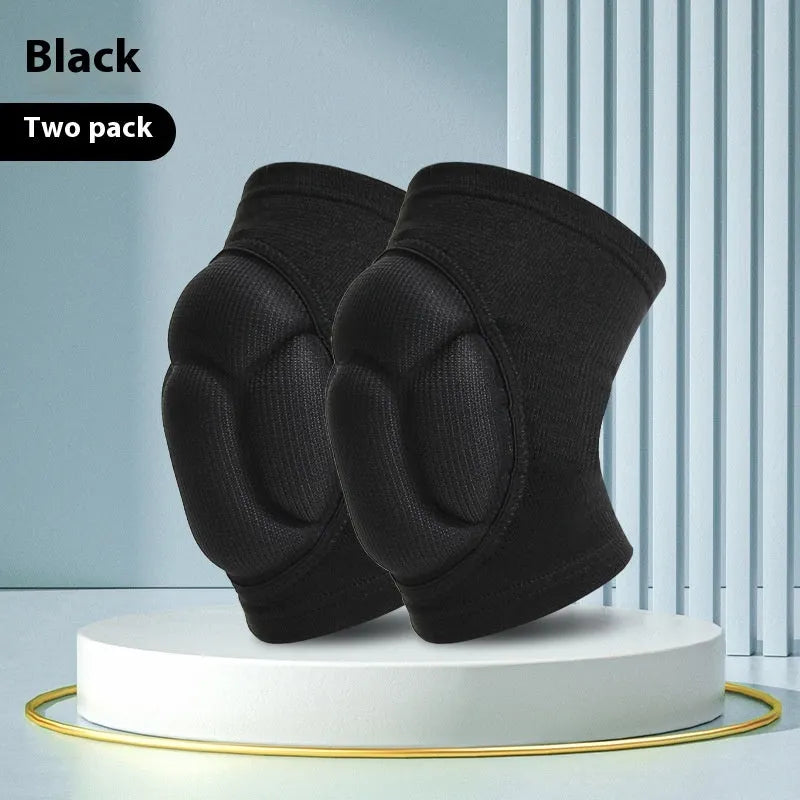 Pair of black thick sponge knee pads for sports protection on a neutral background