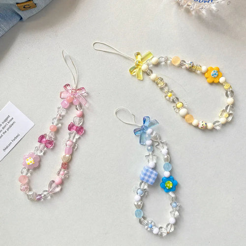 Blue, pink, and yellow floral beaded phone lanyard with plastic resin charms.