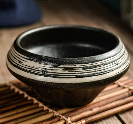 Tall porcelain ceramic Japanese soup bowl with underglaze vintage pattern on wooden table.