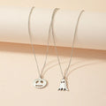 Two silver alloy pendant necklaces: one cartoon pumpkin and one cartoon ghost on a light background