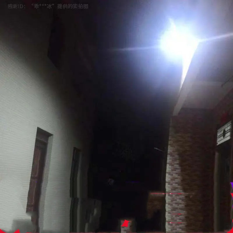 Black Cornucopia solar-powered LED flood light mounted on a garden wall with remote control.