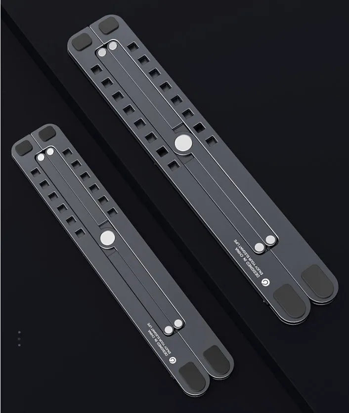 Silver aluminium folding laptop stand adjusted to medium height with a laptop in place.