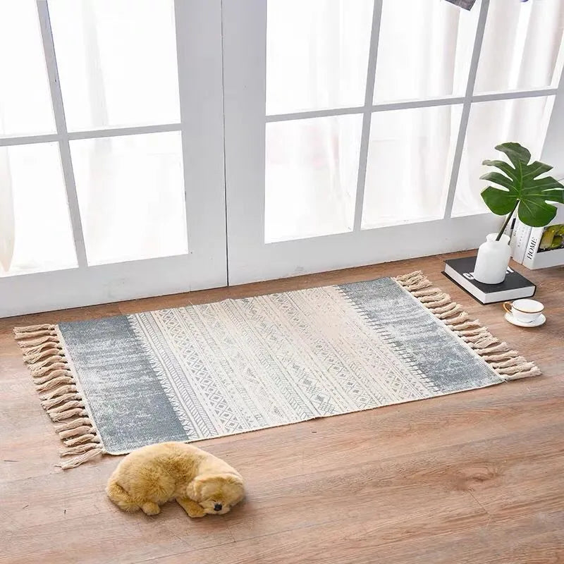 Handwoven cotton linen floor mat 60x90cm in ethnic style with natural plant dye, placed on a wooden floor