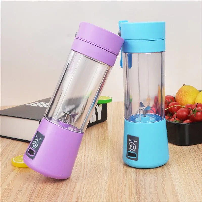 Mini USB-powered centrifugal fruit juicer in pink, with a 400ml plastic cup and stainless steel blade.