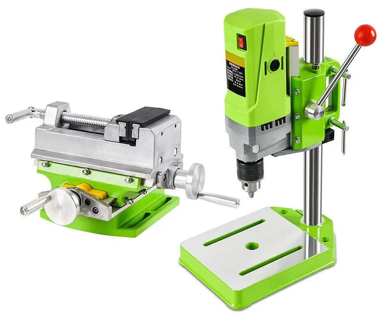 Mini bench drill and milling machine with heavy duty bench pliers on a workbench.